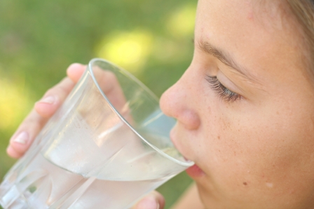 girl drinking a glass of water