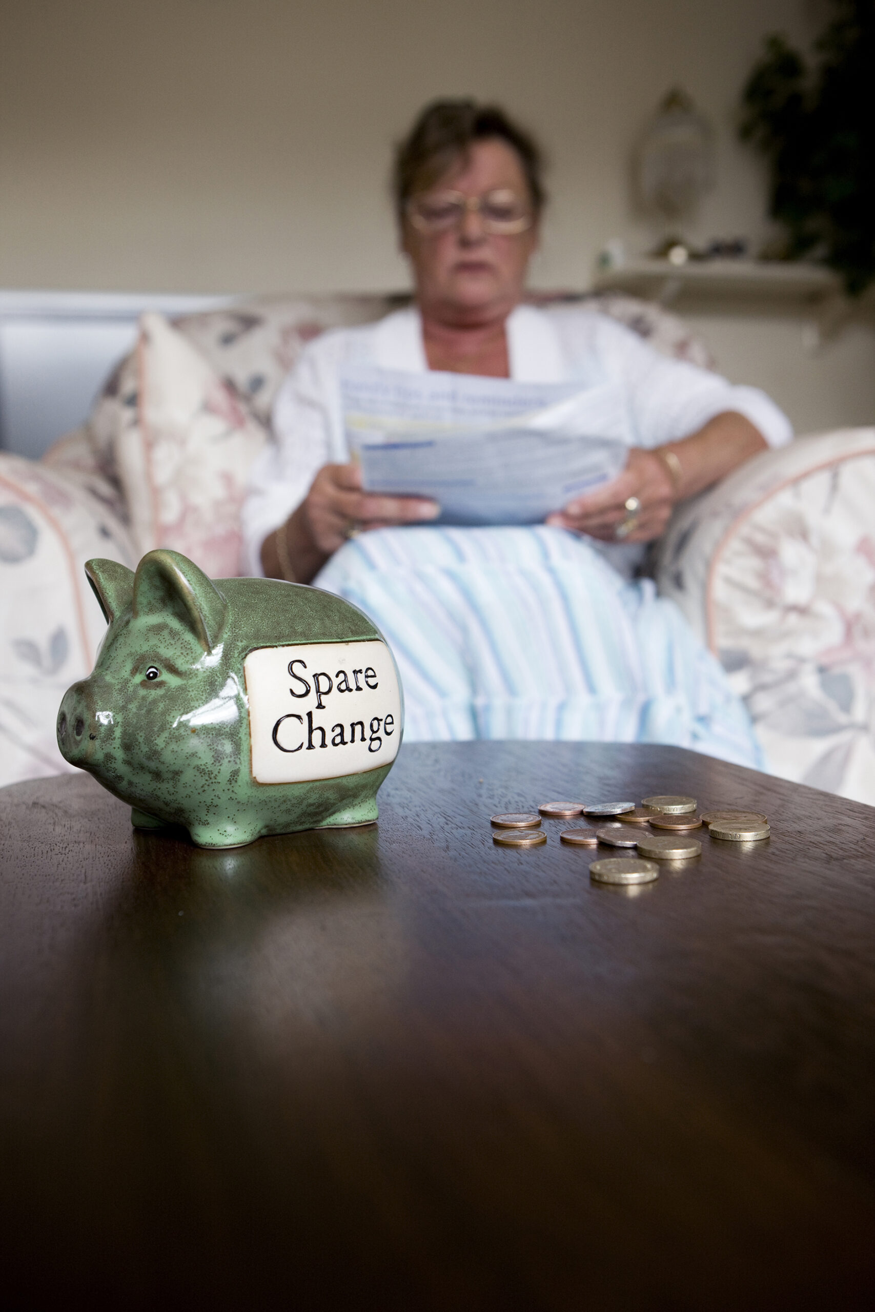 elderly woman looking at bill.