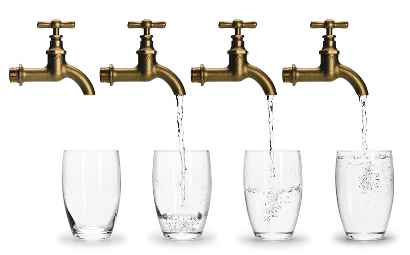 four faucet/taps pouring water in glasses