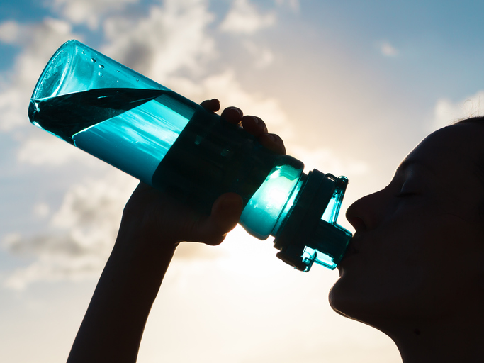 Young woman drinking water.