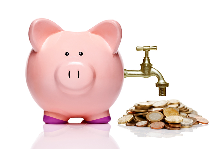 piggy bank with faucet and coins isolated on white