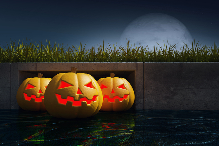 Halloween pumpkins in drain.