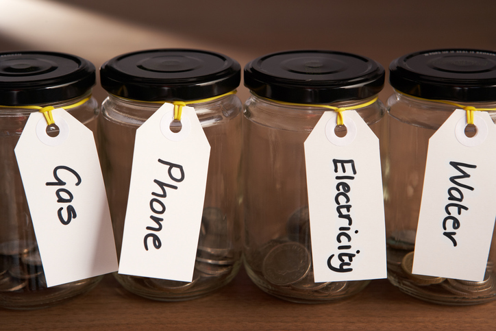 Coins in a jam jar with labels attached in a row