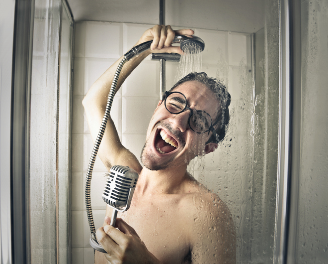 Young man is singing in the shower