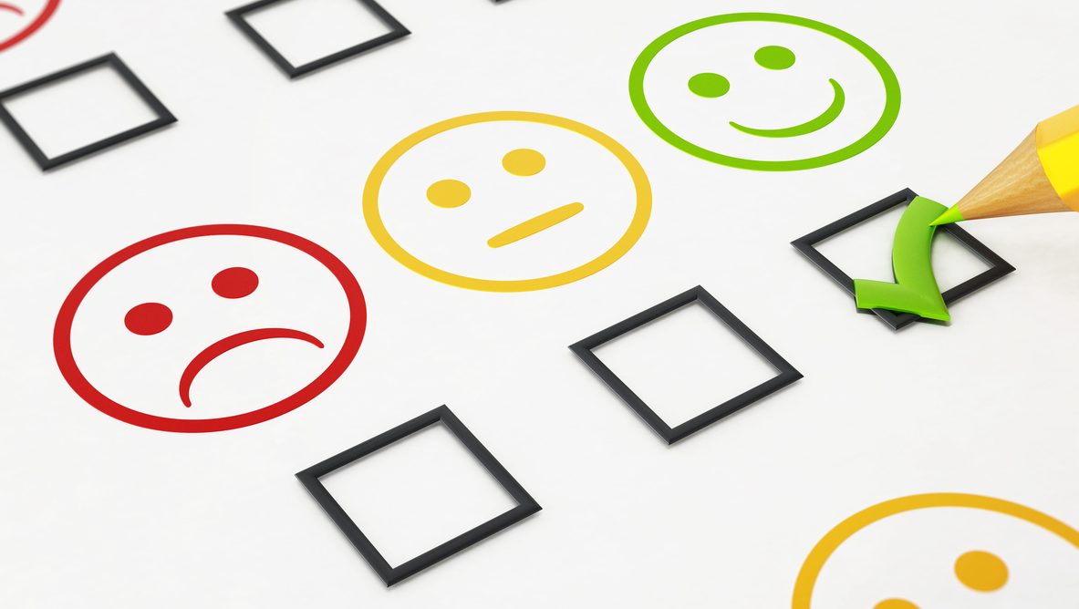 Green checkmark below smiling face symbol in a customer satisfaction survey.
