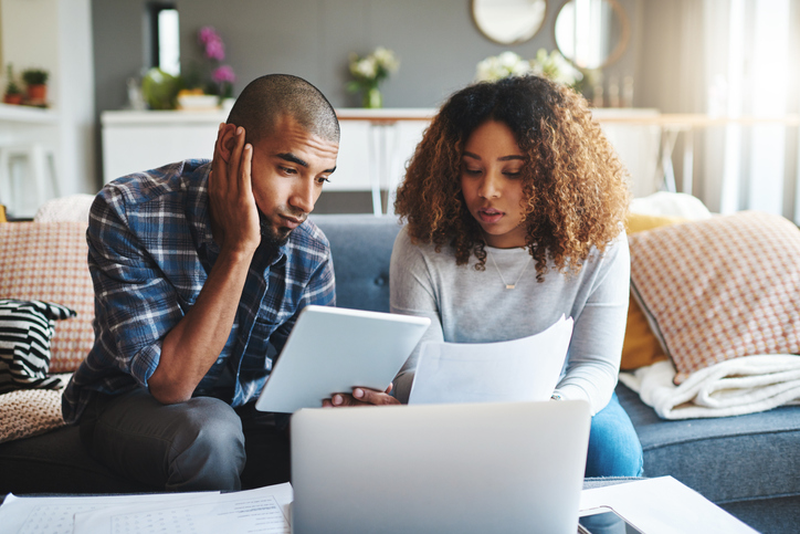 Couple sitting together and looking over their financial paperwork