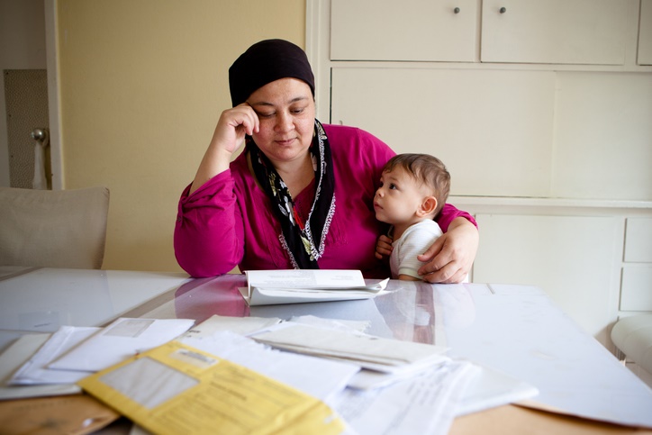 Woman and child looking at bills