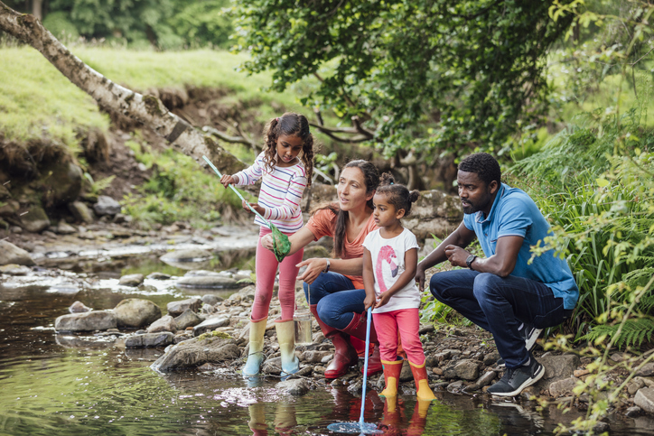 Family by the river catching fish