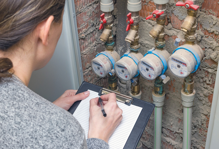 Woman reading the water meter.