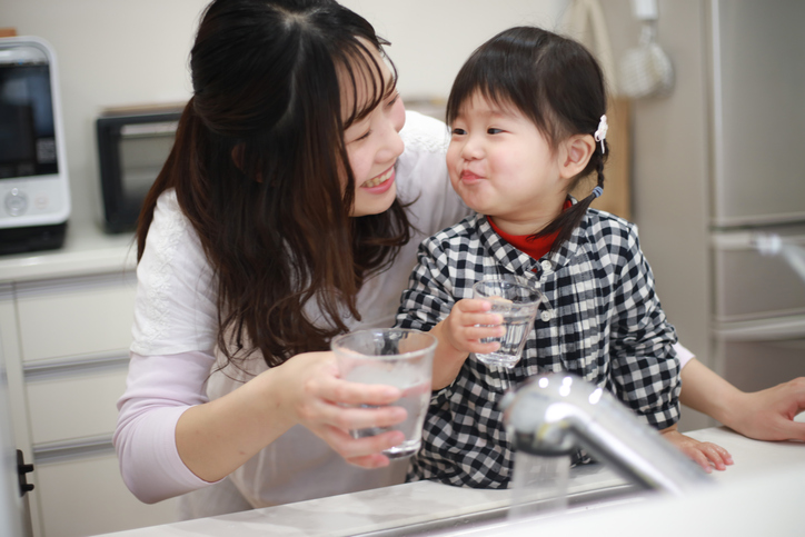 Mother and daughter drinking tap water