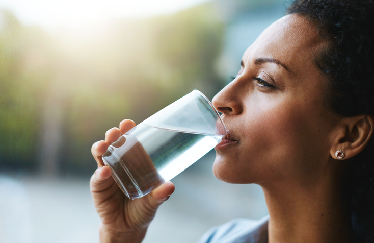 A woman drinking a glass of water