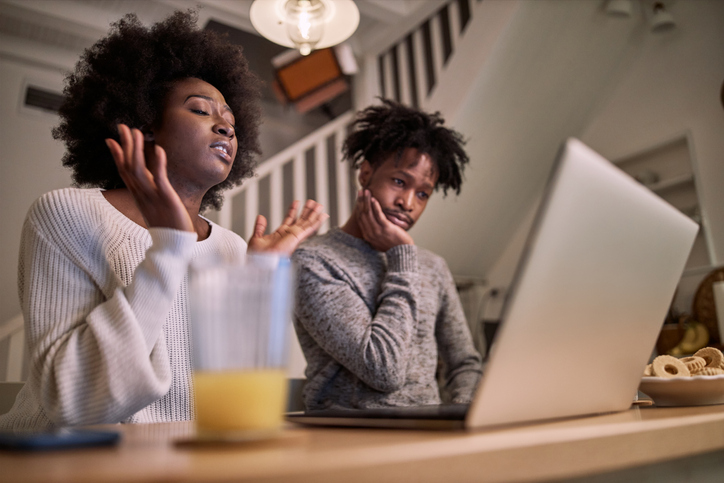 Couple complaining in front of laptop