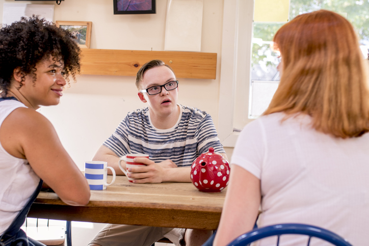 People sharing a pot of tea at a community centre