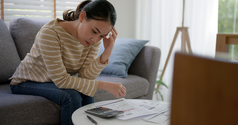 Upset tired young asia woman worried about bills