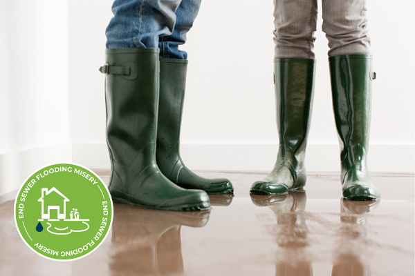 water all over floor with close up on two people's feet wearing wellington boots
