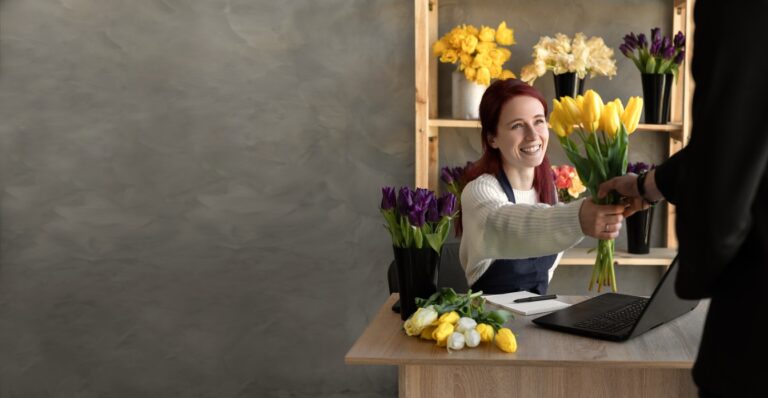 Man buys a beautiful bouquet of tulip flowers in a flower shop.
