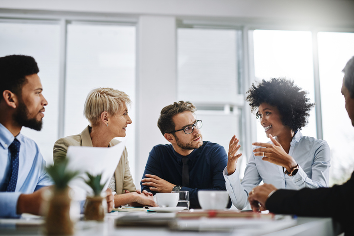 group of business people sitting together in a meeting