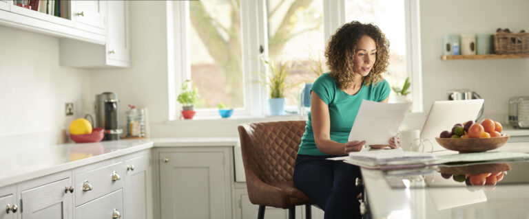 Woman working on computer in ktichen