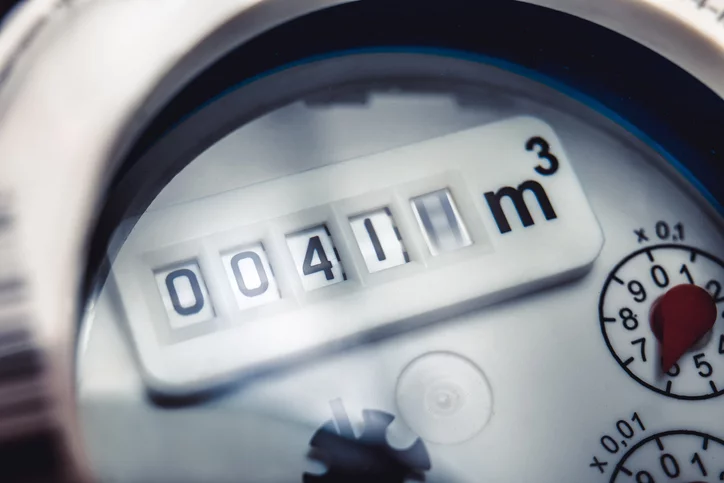 Close up of water meter with rotating digit.