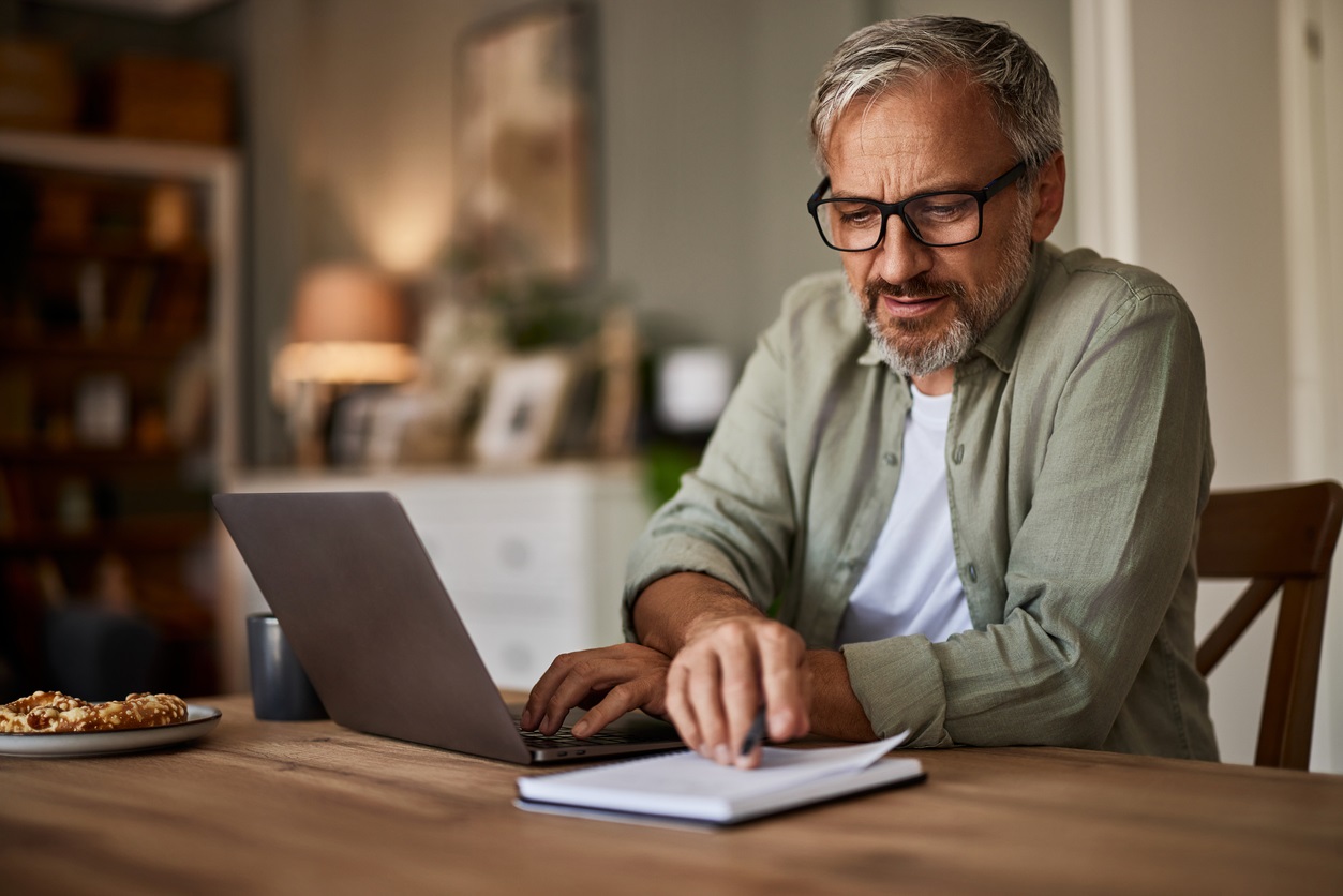 Man checking his accounts on a laptop