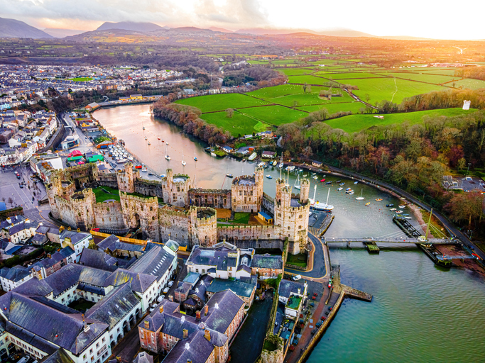 Aerial view of Caernarfon Castle, a medieval fortress in Caernarfon, Gwynedd, north-west Wales, UK