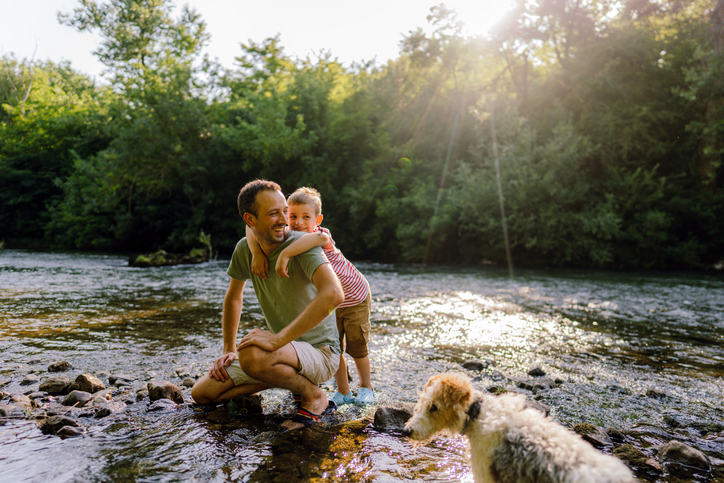 father and son, exploring together beautiful nature by the river