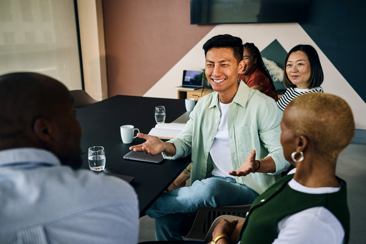 Diverse business team collaborating during meeting in modern office