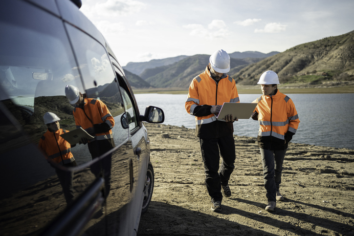 Team working near a reservoir.
