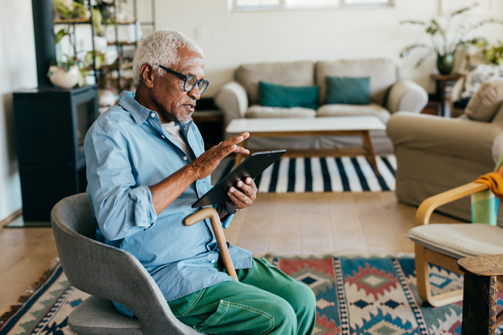 Elderly man using ipad