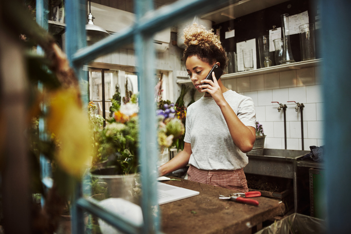 young woman working in her floral boutique